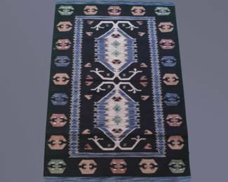 Navy accent rug with bold geometric medallions and decorative motifs.