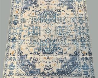 Soft blue traditional rug with an ornate medallion and distressed detailing.