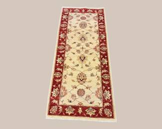 Ivory runner with red floral border and delicate traditional detailing.