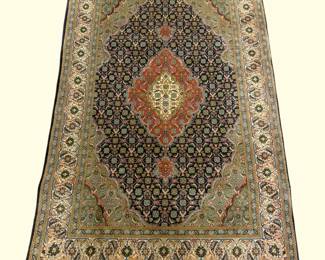 Dark traditional rug with a warm rust medallion and intricate allover pattern.