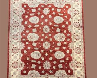 Bold red and ivory rug with repeating geometric circular motifs.