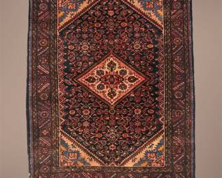 Deep red tribal-style rug with a bold diamond design.