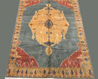 Bold gold, red, and blue rug with a distinctive geometric central design.