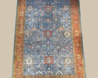 Blue traditional rug with warm rust accents and repeating medallion motifs.