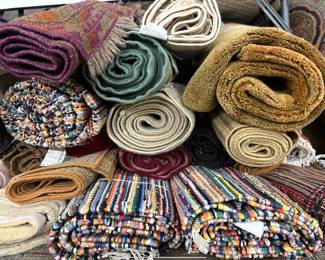Assorted rolled rugs available in a wide variety of colors, patterns, and styles.