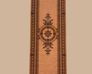 Narrow runner with a warm rust field and elegant central motif.