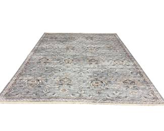 Soft neutral rug with subtle distressed patterning and understated tones.