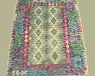 Pastel kilim-style rug with soft geometric detailing.