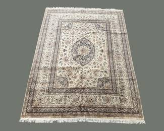 Soft gray traditional rug with a delicate central medallion and detailed border.