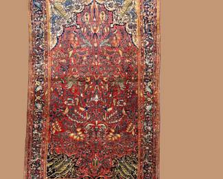 Rich rust traditional rug with dense floral patterning and warm vintage-inspired tones.