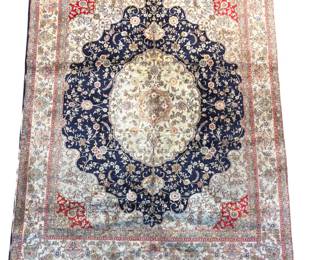 Elegant blue and ivory traditional rug with a large central medallion and floral detailing.