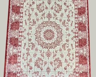 Ivory and red traditional rug with a delicate central medallion and floral border.