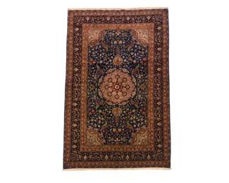 Small warm-toned traditional rug with an intricate central medallion and dark border.