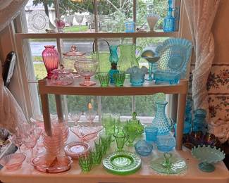 pink Depression glass, the green vaseline/uranium pcs, opalescent ruffeled blue pcs and  hobnail pcs.