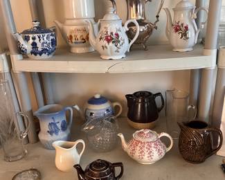 An assortment of coffee, tea and water pitchers.