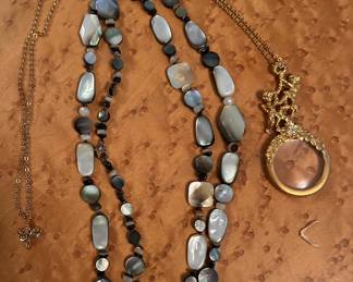 beautiful stone neclace and a cherub magnifying glass with chain