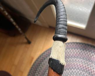 A Swiss walking stick crafted with an animal horn handle.