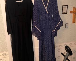 On the left is a black mournig dress  made by Leslie Fay and on the right - is a navy blue & white poka dot dress w/ angel sleeves.  After washing the tag says to ;Line Dry',