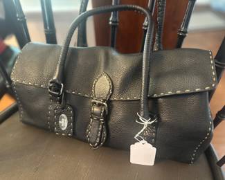Fendi Selleria black pebbled leather handbag featuring prominent contrast stitching, dual rolled handles, and a central buckle closure.