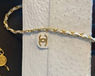 Vintage Chanel white ostrich leather flap bag featuring a gold-tone CC turn-lock closure and woven chain strap.