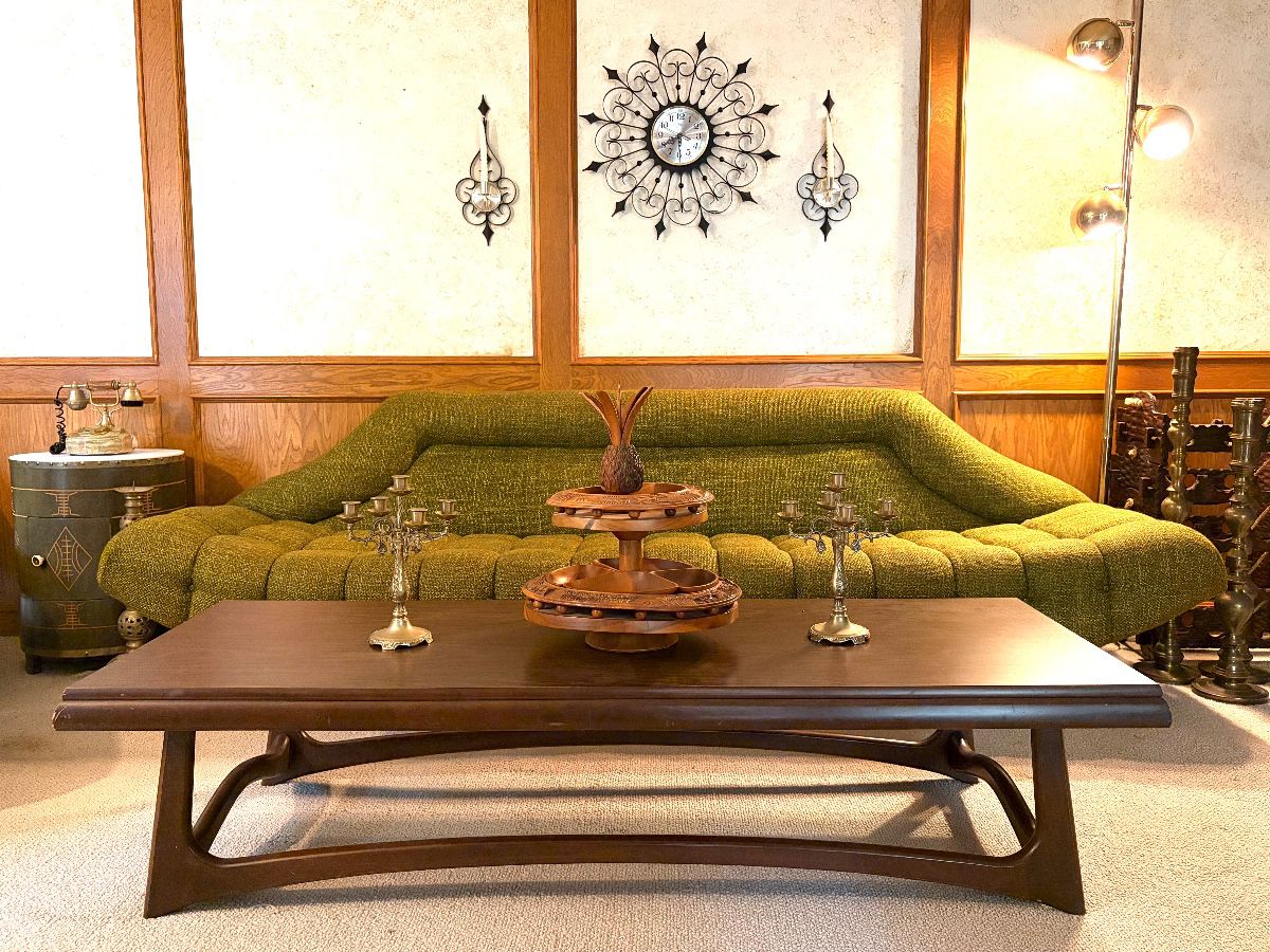 MCM couch and coffee table, two brass candelabra’s and wooden serving tray