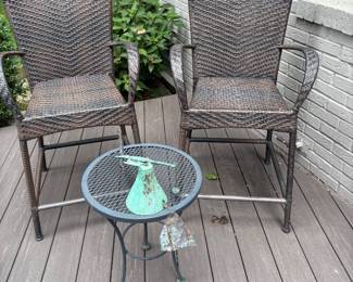 Counter-height patio chairs and side table with copper bell wind chime