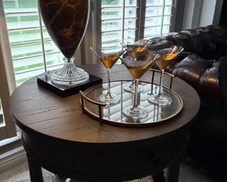 Bernhardt round 2-tier table shown with glass lamp with black/gold shade and mirrored tray with martini glasses
