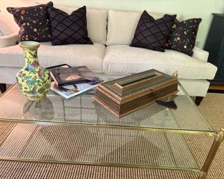 Ivory 2-cushion couch (matched set of 2 available) shown with champagne brass coffee table on casters over sisal rug trimmed in black leather