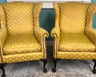 Pair of gold upholstered wing back chairs