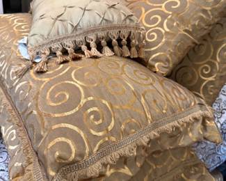 gold and tan decorative bed pillows.