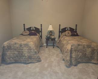 Vintage Wooden Twin Bed with headboard and bedding.