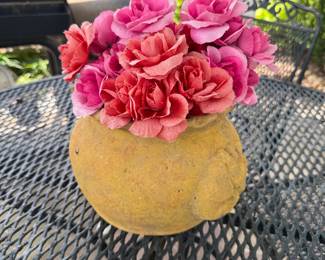Artificial flowers in ceramic pot.