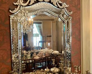 Venetian etched mirror with carved style crest and engraved floral borders. Tall statement piece in the Murano taste. 58 x 32 inches.