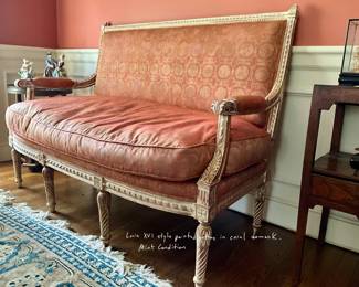 Louis XVI style painted settee in coral damask. Mint condition.