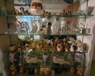 Various figurines; vintage iridescent white/clear blown glass swans (Taiwan-ROC), 1940's-60's Japanese (stamped made in Japan) porcelain Pekingese dog figurine hand-painted with blue-gray and white shading; Vintage Napcoware footed cracked egg vases; Mid-Century ceramic violin dishes; assorted Pekingese figurines; assorted blown glass figurines, one on top a mirrored music box; lucite hummingbird figurines