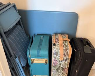 Suitcases and card table set with cloth seats
