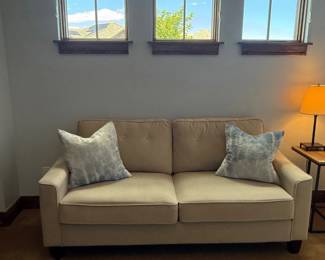 Lot #75- Beige Upholstered Loveseat with Two Accent Pillows