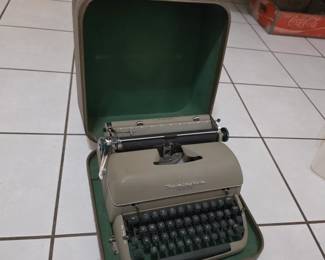 vintage Remington Quiet-Riter portable manual typewriter with its original fitted carrying case.