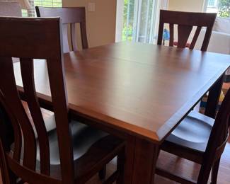 Amish dining table with six chairs and extra leaf