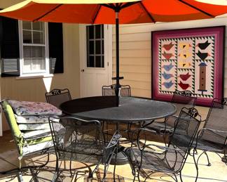 Black wrought iron patio furniture with umbrella
