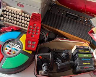 Vintage typewriter, Simon game, Atari gaming console with games, Merlin game