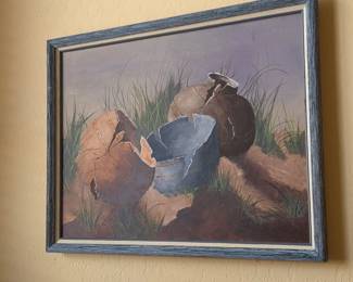 Southwestern/Native-style pottery or clay vessels in a desert-grass setting