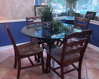 Wicker and glass kitchen table with four wooden chairs