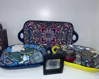 Colorful pottery trays filled with miscellaneous trinkets