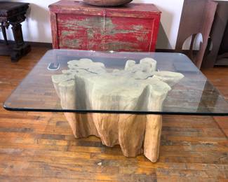 The other of the two glass top tree root base tables