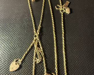 Vintage 9 carat English watch chain with nine karat gold charms.