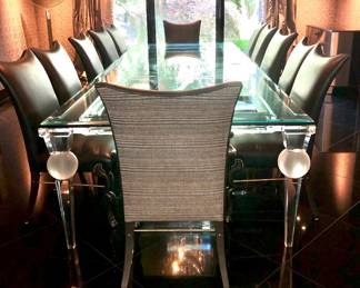 Set of 12 dining chairs are available at my gallery, the single piece (12’ by memory) glass top dining table on acrylic & glass base will be available for purchase from the house. If you decide to purchase the table, you must have a plan for professional movers to move this gigantic piece of furniture/serious inquiries only!