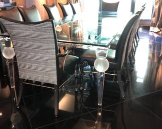 Set of 12 dining chairs are available at my gallery, the single piece glass top dining table on acrylic & glass base will be available for purchase from the house. If you decide to purchase the table, you must have a plan for professional movers to move this gigantic piece of furniture/serious inquiries only!