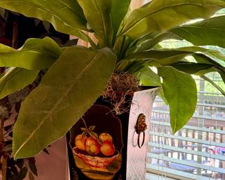 Tole pot with greenery on marble top table