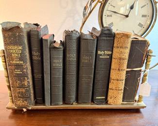 Selection of antique bibles in a brass shelf